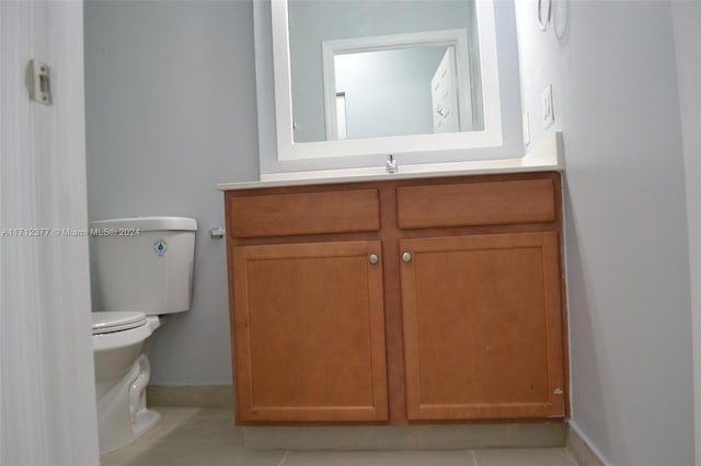 bathroom with tile patterned floors, vanity, and toilet