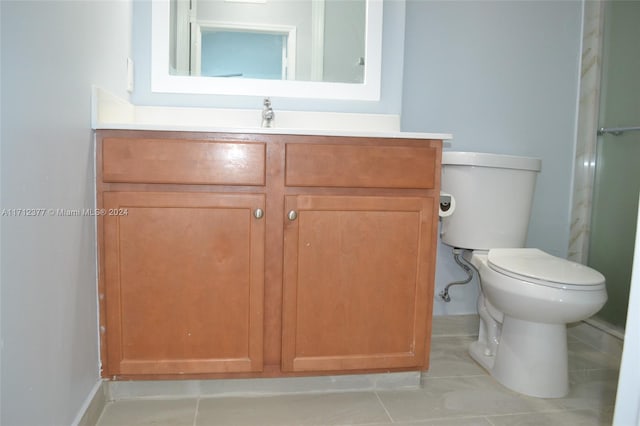 bathroom featuring tile patterned flooring, vanity, and toilet