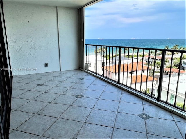 balcony featuring a water view and a view of the beach