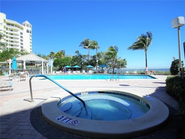 view of swimming pool with a community hot tub, a patio, and a gazebo