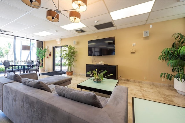 tiled living room with plenty of natural light and a drop ceiling