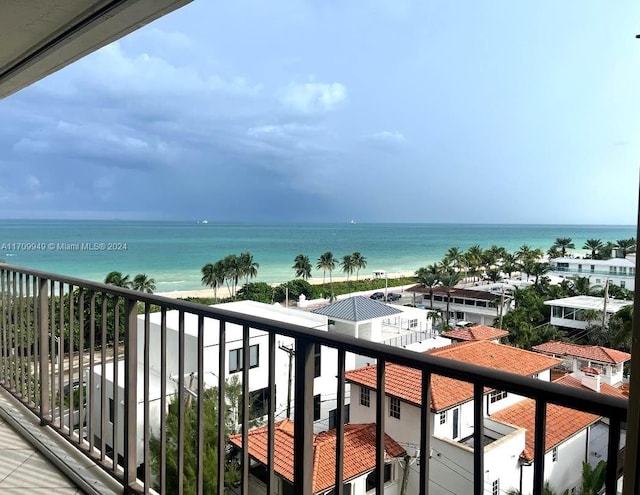 balcony with a water view and a beach view