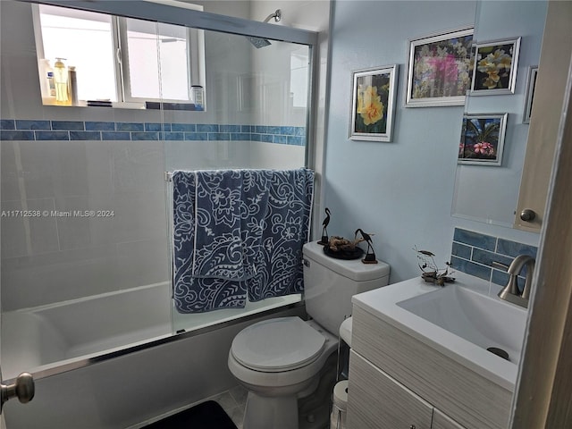 full bathroom featuring tile patterned flooring, toilet, vanity, and tiled shower / bath