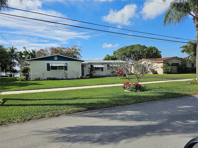 ranch-style home with a front yard