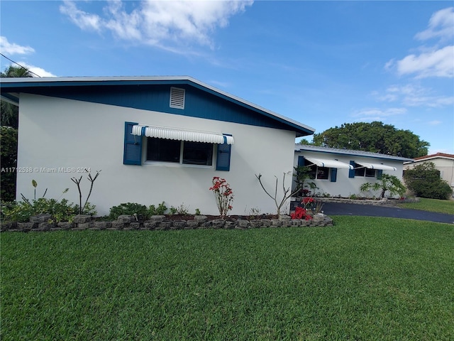 view of property exterior featuring a yard