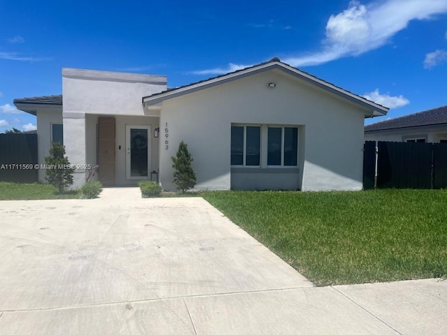 ranch-style house with a front lawn