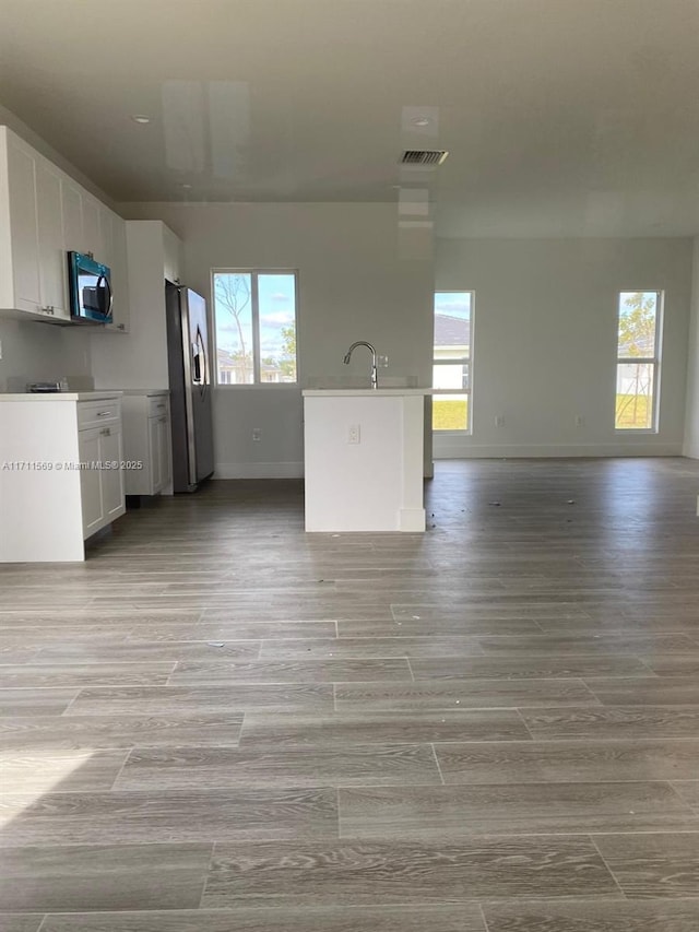 unfurnished living room featuring sink