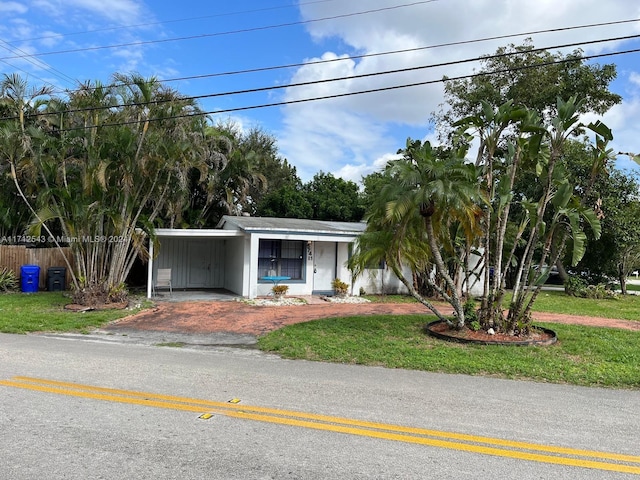 view of front facade featuring a front lawn and a carport