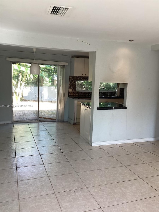 kitchen with gray cabinets, decorative backsplash, and light tile patterned floors