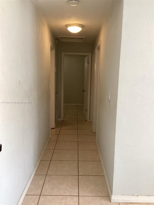 hallway featuring light tile patterned floors