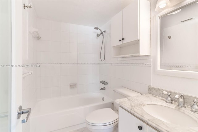 full bathroom featuring backsplash, vanity, tiled shower / bath, and toilet