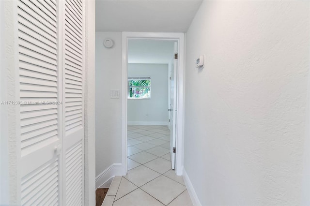 hall featuring light tile patterned floors