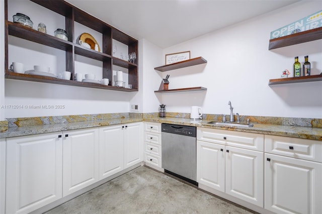 kitchen with light stone counters, dishwasher, white cabinets, and sink