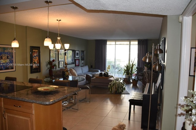 kitchen featuring a textured ceiling, light tile patterned floors, a notable chandelier, and floor to ceiling windows