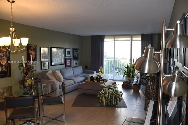 living room featuring tile patterned flooring, a notable chandelier, a textured ceiling, and a wall of windows