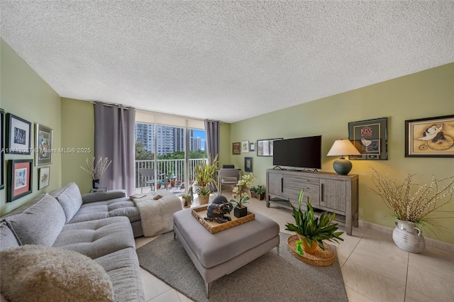 living room featuring a textured ceiling, light tile patterned flooring, baseboards, and floor to ceiling windows