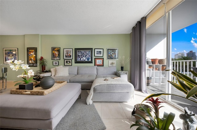 living area with expansive windows, a view of city, and a textured ceiling