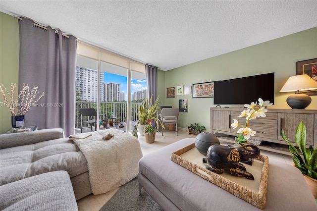 living room with floor to ceiling windows and a textured ceiling