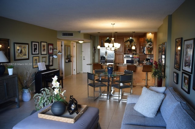 tiled living room featuring a chandelier