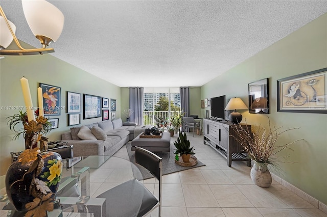 living room with light tile patterned floors, baseboards, and a textured ceiling