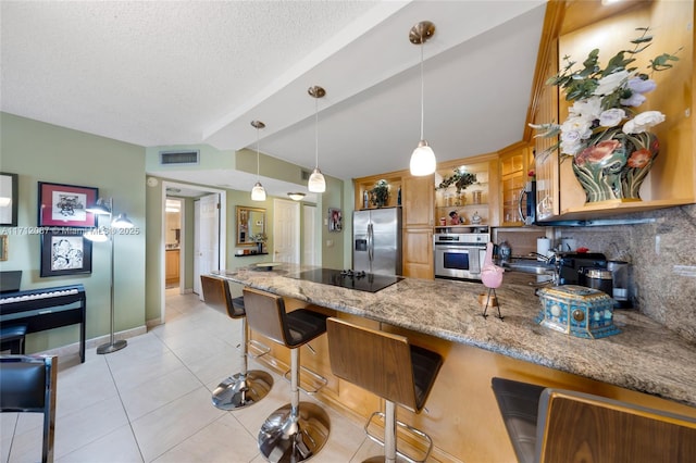 kitchen featuring decorative light fixtures, a breakfast bar area, open shelves, stainless steel appliances, and visible vents