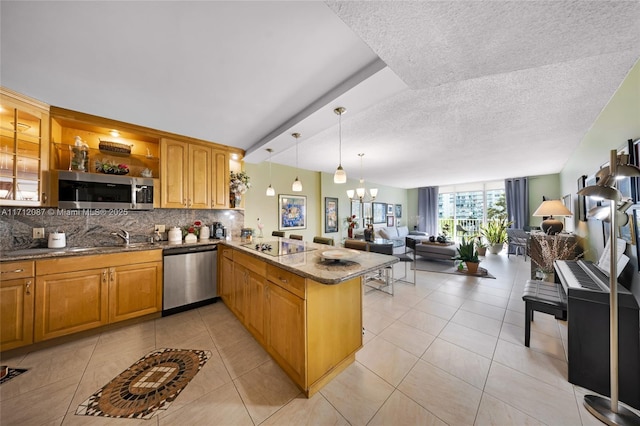 kitchen with hanging light fixtures, decorative backsplash, an inviting chandelier, appliances with stainless steel finishes, and a peninsula