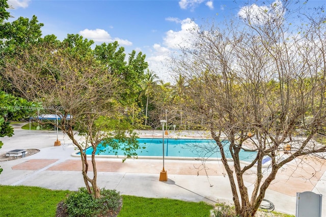 outdoor pool with a patio area