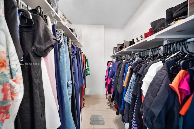 walk in closet featuring light tile patterned flooring