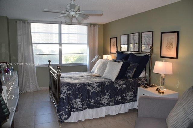 bedroom with light tile patterned flooring, a textured ceiling, and ceiling fan