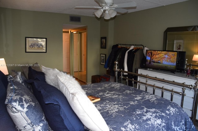 bedroom with ceiling fan and a textured ceiling