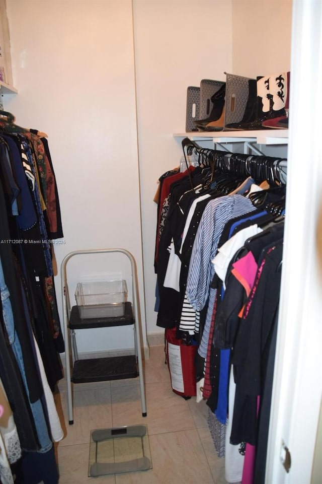 spacious closet with light tile patterned floors