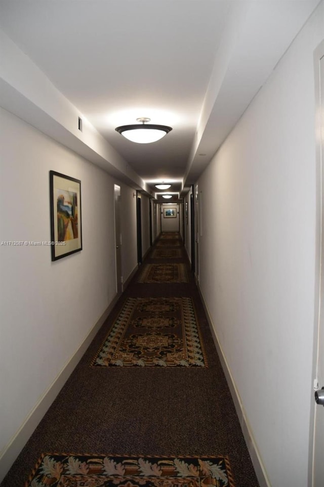 hall with dark carpet