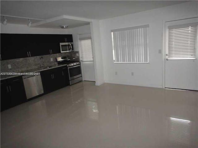 kitchen with stainless steel appliances, a wealth of natural light, and sink