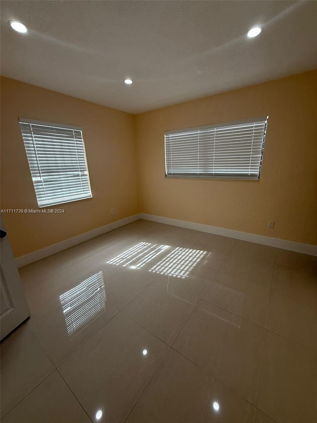 spare room with tile patterned floors