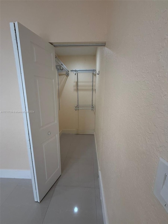 spacious closet with light tile patterned flooring