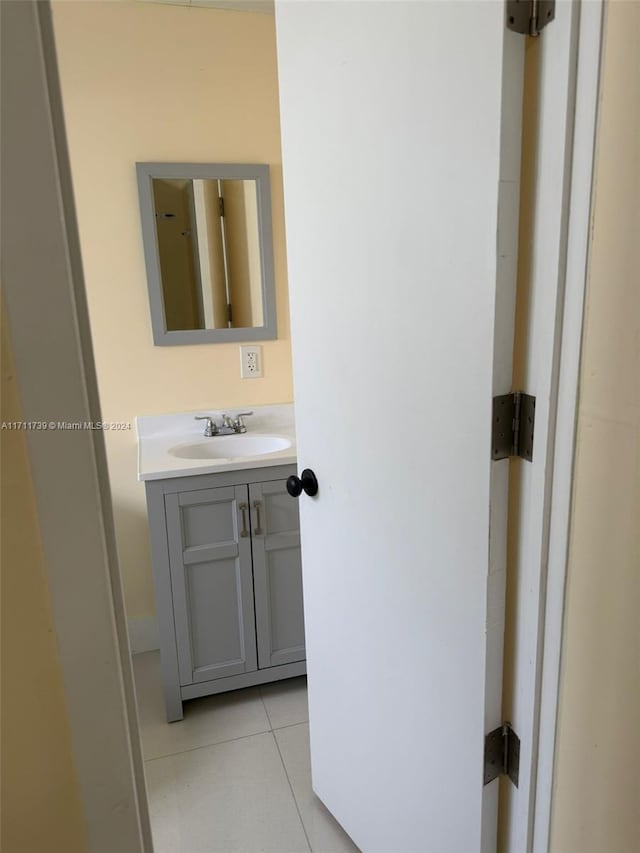 bathroom with tile patterned floors and vanity