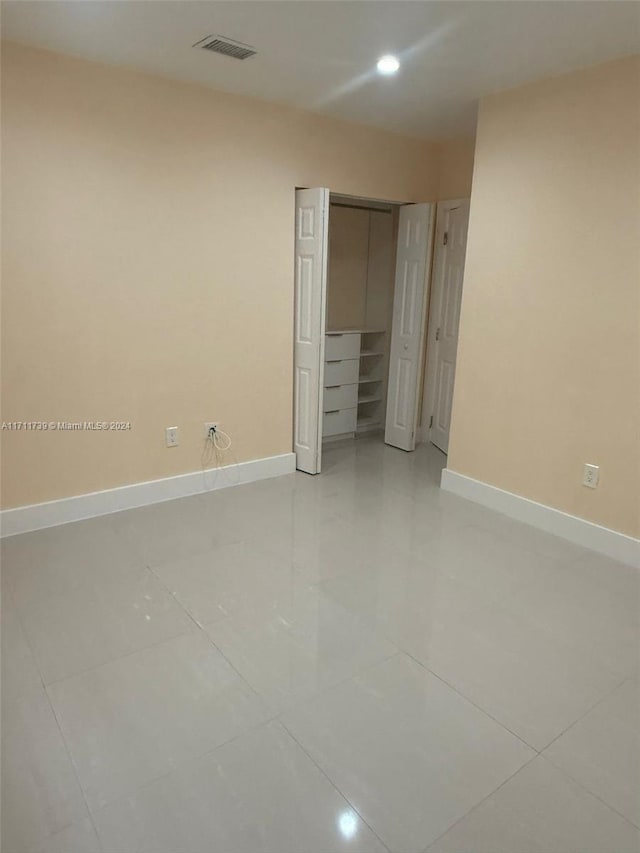 unfurnished bedroom featuring a closet and light tile patterned flooring