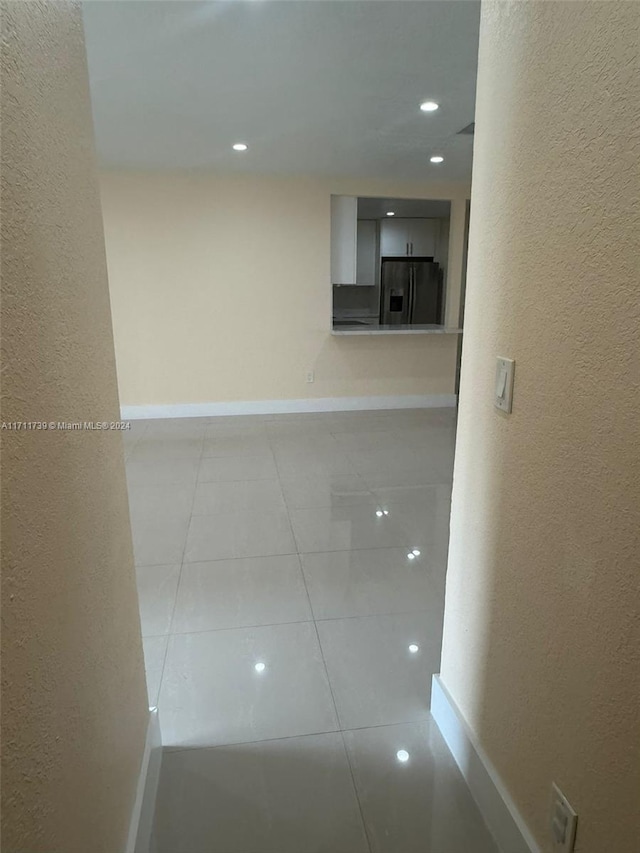 corridor featuring light tile patterned flooring