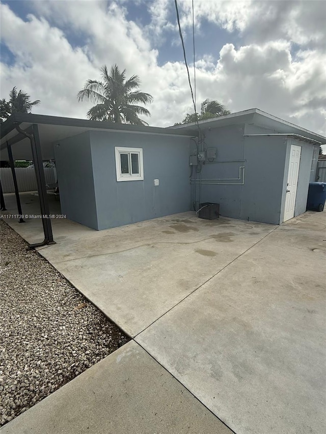 view of side of home with a patio area