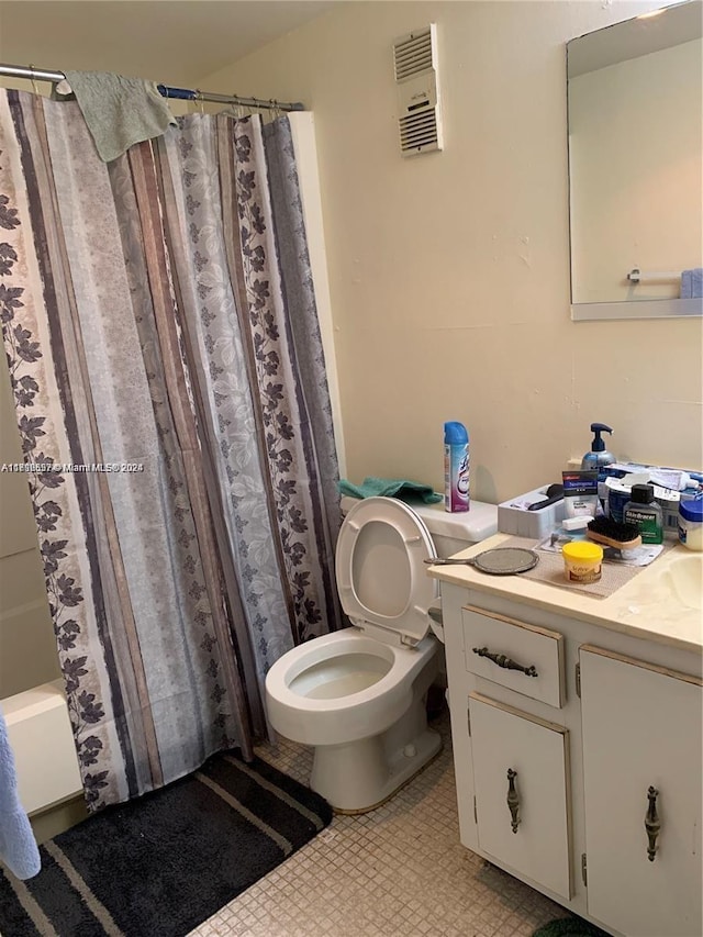 full bathroom featuring shower / bath combo, vanity, and toilet