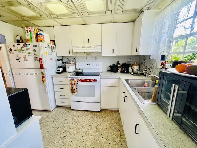 kitchen featuring sink, white cabinets, and white appliances