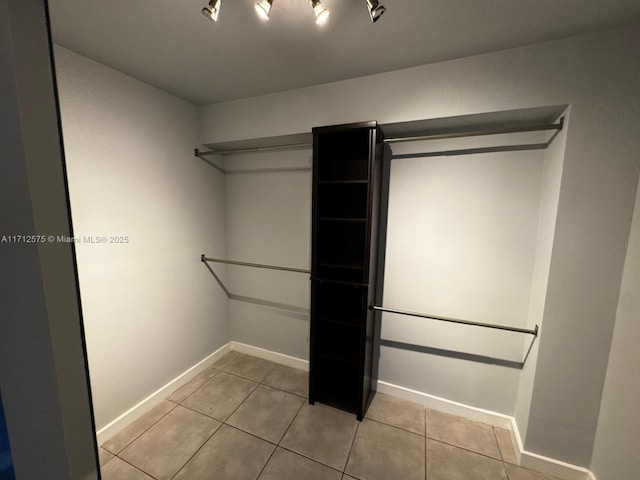 walk in closet featuring light tile patterned flooring