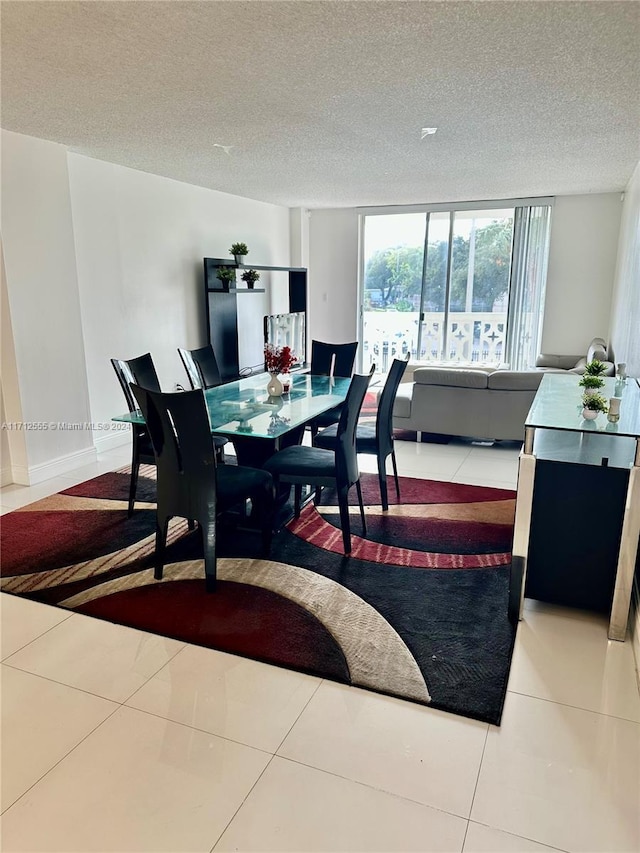 dining room with tile patterned floors and a textured ceiling