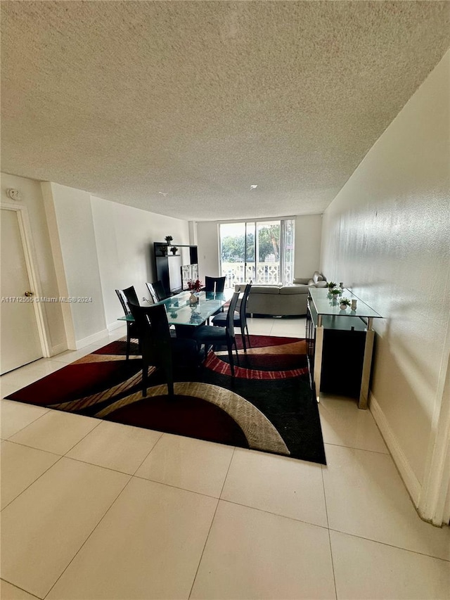 tiled dining area featuring a textured ceiling