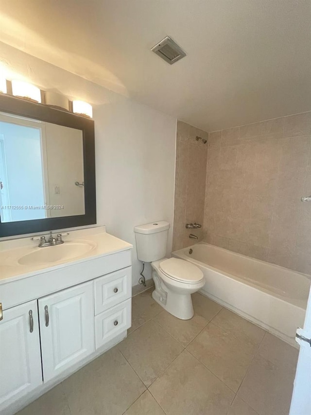 full bathroom with tile patterned flooring, vanity, toilet, and tiled shower / bath combo