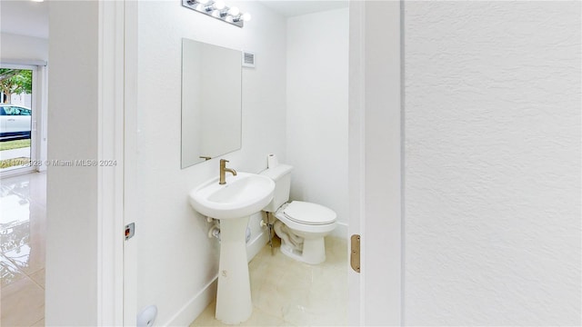 bathroom with tile patterned flooring and toilet