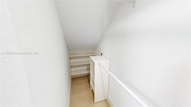 spacious closet with light tile patterned floors