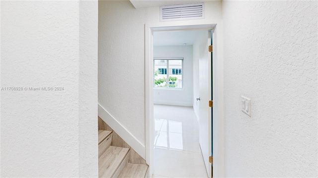 hall with tile patterned flooring