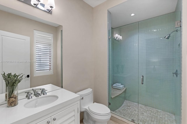 bathroom with toilet, an enclosed shower, and vanity