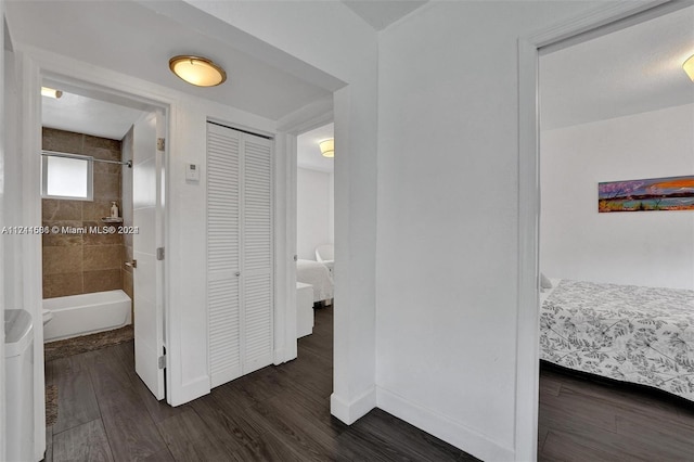 corridor with dark hardwood / wood-style flooring